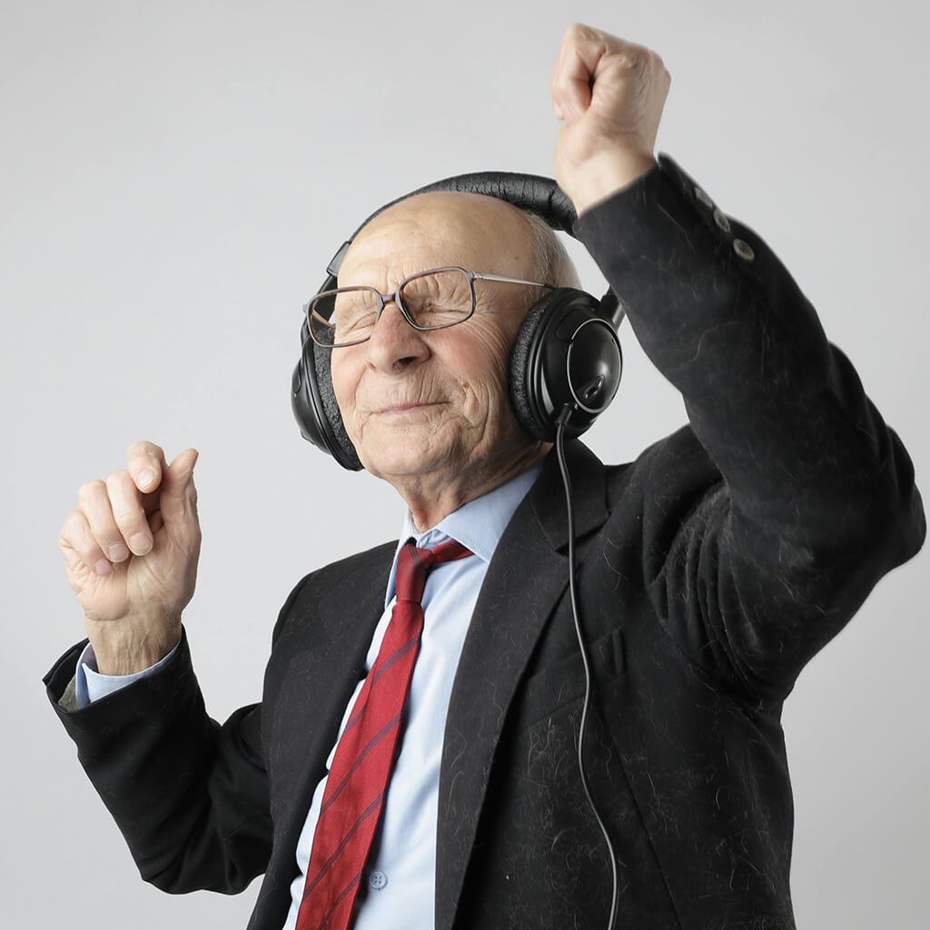 Pensioen oudere man danst met koptelefoon